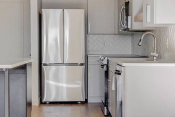 a kitchen with a refrigerator and a sink